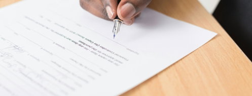 person writing on white paper